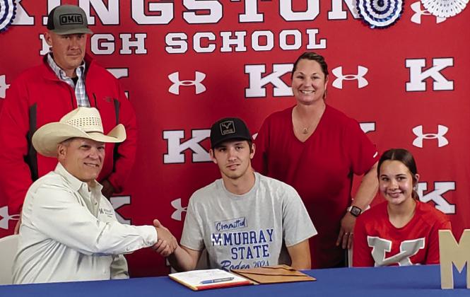 Delton O’Steen signs to be on he rodeo team at Murray State College while surrounded by his family and Coach Todd Smith. Crystal Burnezky-Robertson • The Madill Record