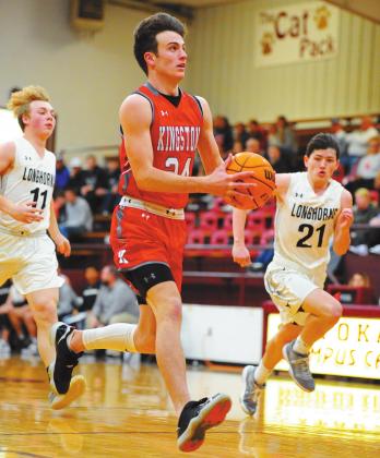 Crockett Uber •For The Madill Record Kingston boys basketball player Braden Matchen drives past a pair of Lone Grove defenders in a game Jan. 23. The Redskins defeated the Longhorns 52-32.