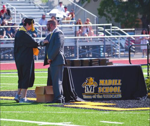 Madill senior Jon Venable elbow bumps MHS prinicpal Jason Ward during the school’s commencement ceremony on June 6. Matt Caban • The Madill Record