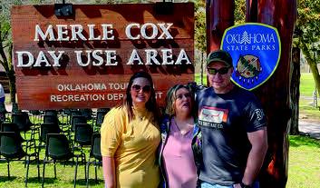 Family members stand in front of the sign dedicated to Merle Cox, Jr. Courtesy photo