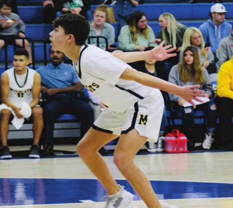 Brylan James defends during the Madill v Crooked Oak game on December 18, 2021. Bre Eppler