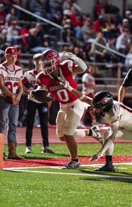 Kingston High School Jaksyn Martin, pictured left, runs the ball during the Kingston v. Sperry game. Parks Ratzlaff, pictured right, tries to get out of his oppponent’s grasp.