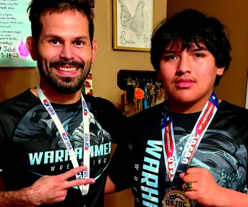 Pictured left: Alex Sarabia holds his winning bracket. Pictured right: Coach Peter Hammer and Sarabia pose with Sarabia’s championship ring. Courtesy photos