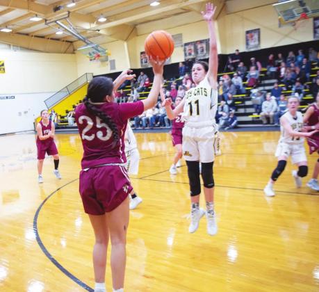 Madill senior forward Kristen Chapa (11) attempts to block a shot by Byng senior guard Alexis Barnett (25). Lony Dorman • The Madill Record