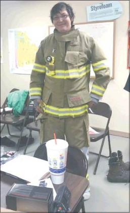 Courtesy Photo Chris Jackson tries on the new Bunker Gear For the Texoma Fire District firefighters.