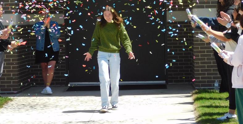 Madill High School senior Mia Laird walks through a cheering crowd of fellow students and a shower of confetti as she is announced as a 2024 OGE Positive Energy Scholar during a surprise celebration. Courtesty photo