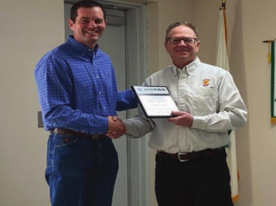 Cody Bradshaw of the Marshall County Economic Development Authority presented Jim Dowling and Super C with an Appreciation Plaque. Summer Bryant • The Madill Record