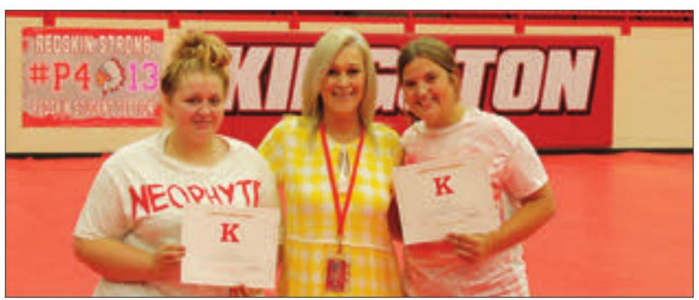 Kathy Burnett presenting the April Burch Scholarship to Alayna Cox and Alyssa Henry. Gary Jackson