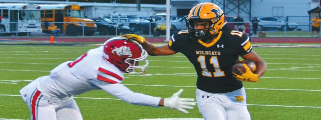 Madill Sophomore RJ Morris, #11, pushes his way through players in the Wildcats v. Bulldogs game. Summer Bryant • The Madill Record