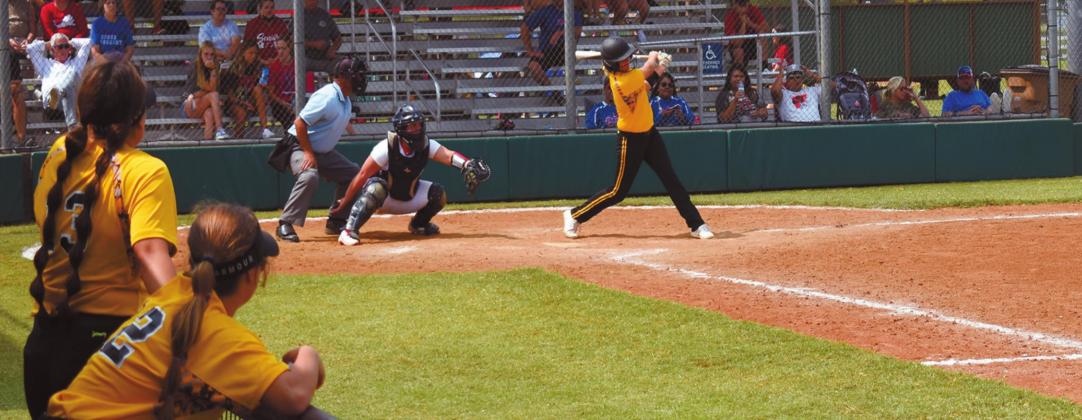 A few Madill Lady Wildcats watch as one of their own are at bat during the Broken Bow game at the Durant Fast Pitch Softball Tournament on September 20. James Bowser • The Madill Record