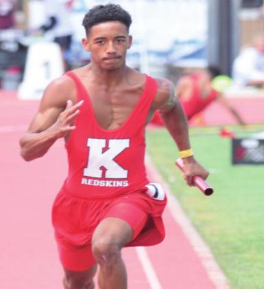 Devin Tipton gives it his all during the relay at the State Track Meet. Brian Blansett