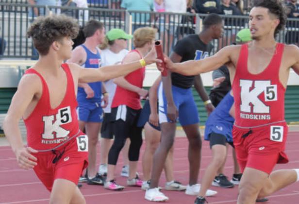 Jesse Rose passes the baton to Damon Rowe during the relay at the State Track Meet. Brian Blansett