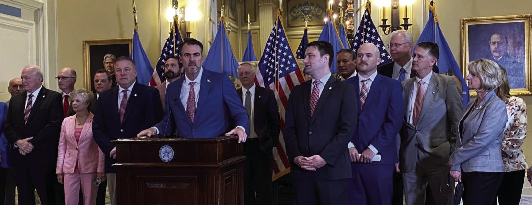 Oklahoma Gov. Kevin Stitt, at lectern and flanked by legislative leaders, discusses details of a budget agreement at the Capitol in Oklahoma City on Wednesday, May 14, 2025. Paul Monies • Oklahoma Watch