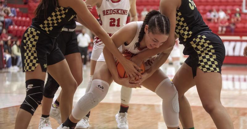 Cassidy Walker fights off a few Marietta Indians to keep control of the ball. Matt Swearengin