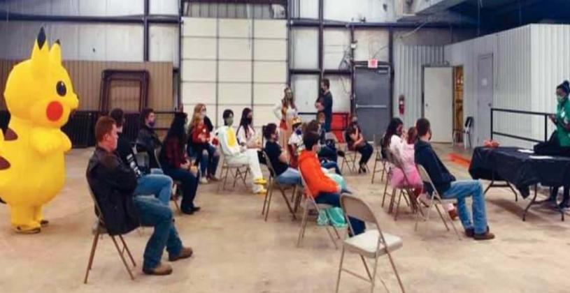 Left: Keegan Varner was voted to be the recipient of a pie to the face. Right: 4-H members from Marshall and Johnston Counties attended the Annual County Night on October 24. Courtesy photos