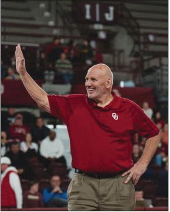 Roger Frizzell standing center mat during his halftime honor. Courtesy photo