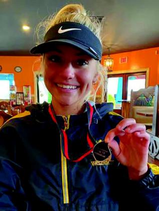 Kellanie Lowe placed in the top 10 at the Dickson tournament with a score of 101. Pictured above: Lowe is posing with a medal she won at a tournament in 2022. Courtesy photo