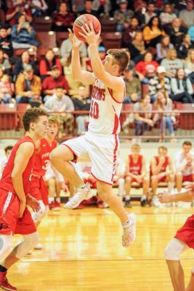 Senior Kaden Johnson runs jumps for a score. He had 6 points in the KIngston vs. Broken Bow game on December 19.