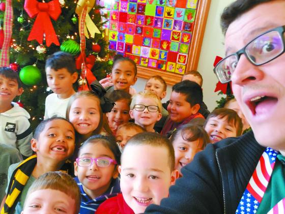 Students from Mrs. Courtney Sharp’s kindergarten class take a selﬁe with Madill Record managing editor Matt Caban during the Madill Public Schools’ Eighth Annual Joyce Coleman Christmas with the Kids on Dec. 17.