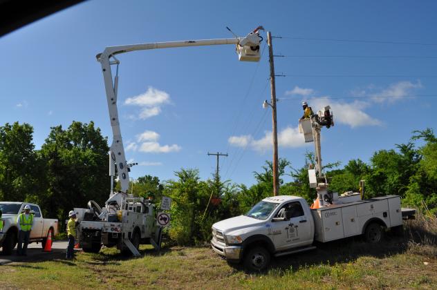 Imperium Utility Services out of Oklahoma City were on hand to help get Madill power back on. Photo by Charles White