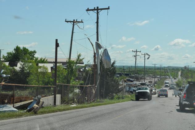 Sheet metal pieces hang like pieces of cloth blowing in the breeze on Smiley Road. Photo by Charles White