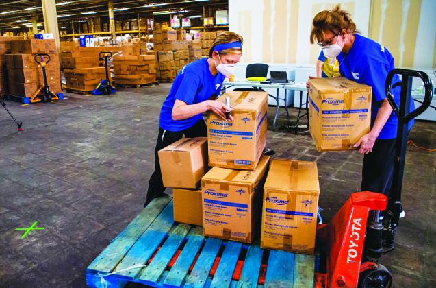 Teri Murphy, left, Sheryl Kline, of the Oklahoma Medical Reserve Corps., gathers boxes of personal protection equipment (PPE) and medical supplies to send out to facilities in the state at a warehouse where the State of Oklahoma has amassed a stockpile for its COVID-19 response in Oklahoma City, Okla. on Tuesday, April 7, 2020.  Photo by Chris Landsberger - The Oklahoman