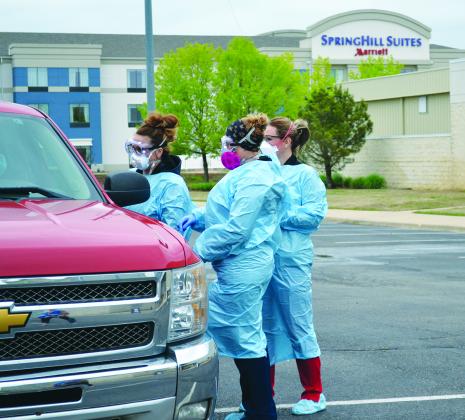 Nurses with the Carter County Health Department stake a mock COVID-19 test at a mobile testing site at the Ardmore Convention Center on April 2. Photo by Matt Caban - The Madill Record