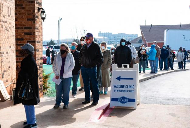 Oklahomans age 65 and older stood in line awaiting their COVID-19 vaccine at Ebenezer Baptist Church in Northeast Oklahoma City on Jan. 26, 2020. Oklahoma City County Health Department expected to administer 1,100 doses that day. (Whitney Bryen/Oklahoma Watch)