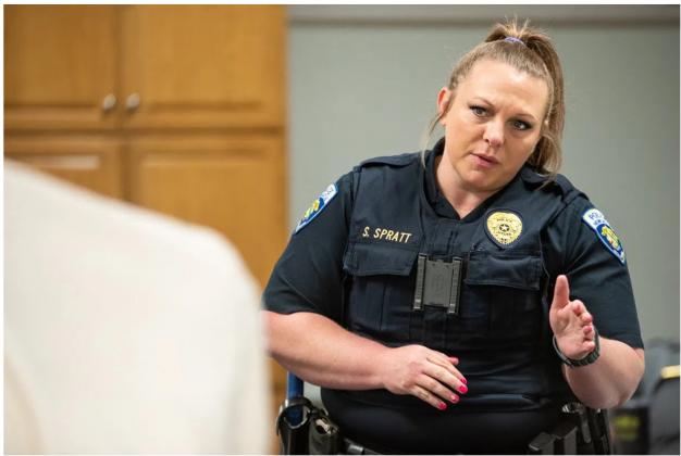During a training exercise, Newcastle police Sgt. Shelly Spratt assessed a delusional woman, played by an Oklahoma City police detective, who is refusing to come out of a dog house. The role-playing scenario was part of a 40-hour course that teaches law enforcement how to recognize and respond to mental health crises. (Whitney Bryen/Oklahoma Watch)