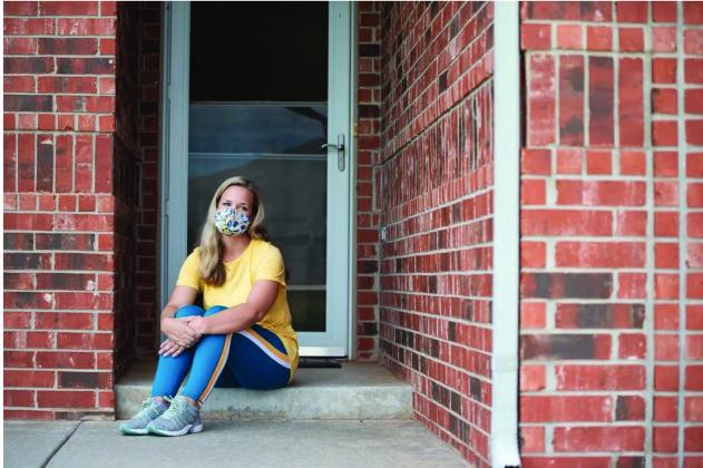 Nicci Francis, a librarian at Piedmont High School, tested positive for COVID-19 shortly after the school year began. Francis, pictured here on her front porch, said schools need to be able to take measures like requiring masks to keep their staff and students safe. (Whitney Bryen/Oklahoma Watch)