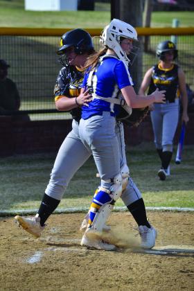 Emily Austin crosses over home plate seconds before the ball reaches the catcher. Summer Bryant • The Madill Record