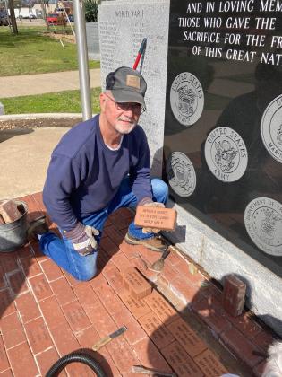 Richard Bonnet holds the brick to commemorate his late father, Arthur Bonnet. (Summer Bryant)