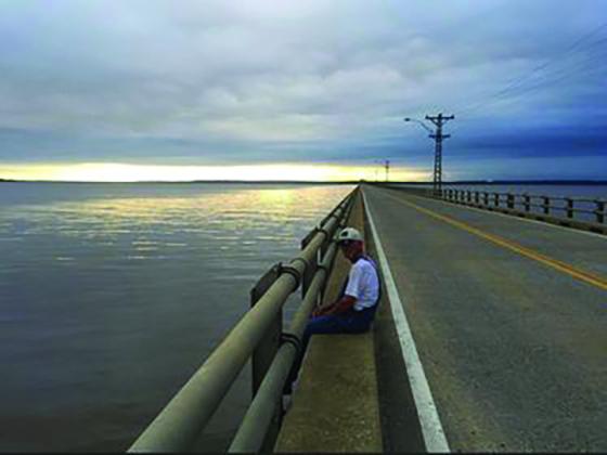 Gary Ayres sits on the Roosevelt Bridge in 2015. (Photo by Paula Ayres)