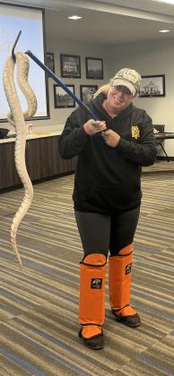 Billie Karger learns how to wrangle a snake by the Oklahoma Animal Control Association. (Courtesy photo)