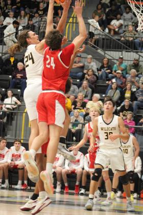 Reid Cason, Kingston, and Ethan Wilkerson face off at the goal. (Summer Bryant)