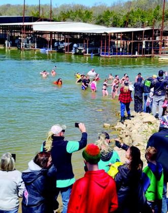 Guests jumped into freezing water during the Polar Plunge during the Burning of the Socks event at Buncombe Creek.