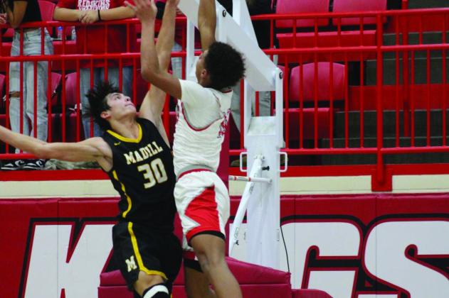 JD Runyan, Madill, and a Kingston Redskin battle it out on the court. Photo by Summer Bryant