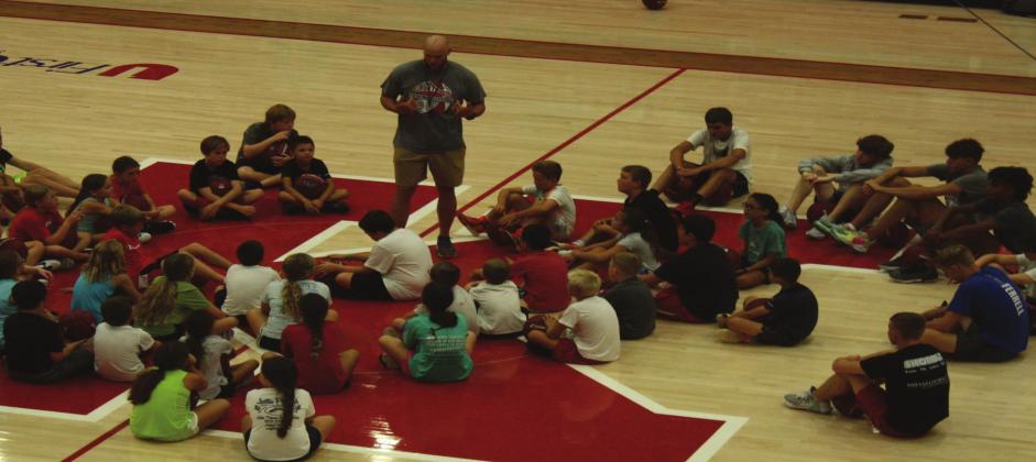 The Kingston Boys Basketball Head Coach Bobby McAdoo talking to the 3rd through 5th grade students. Gary Jackson
