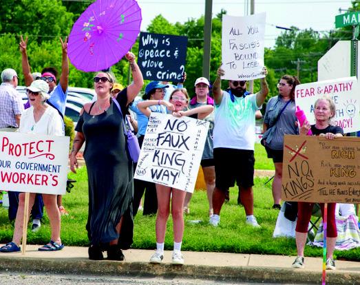 Many protestors line the street in Durant to protest President Donald Trump's policies. Matt Swearengin