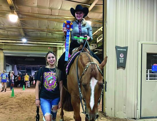 Kingston student Ella Weaver took home the gold at the Pinto World Championships held June 12 through June 17. Weaver and her horse, What a Chocolatey (aka Dundee), won the World Title in the Walk Trot Solid Trail category. Pictured: Weaver on Dundee with Gabby Reyes, Dundee’s owner. Courtesy photo