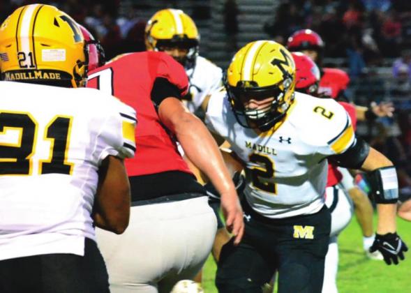 Stephen Sisco tries to break through the defense during the Madill vs. Pauls Valley game wh ile Ezekiel Fuentes assists. Summer Bryant • The Madill Record