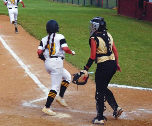 Senior Ximena Gomez, #13, crosses home plate in the Home Senior Night game against Marietta. The Lady ‘Cats won 8-7 in overtime. James Bowser • The Madill Record
