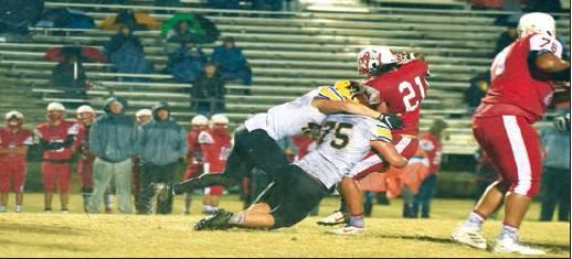 Dibbon Marris • Courtesy Photo Madill senior defensive tackle EJ Holliday (75) and a teammate tackle McLoud’s Clint Campbell.