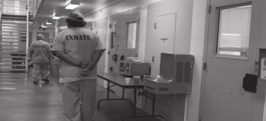 An inmate is seen standing in the mental health ward at Joseph Harp Correctional Center in Lexington in this 2018 file photo. Whitney Bryen • Oklahoma Watch