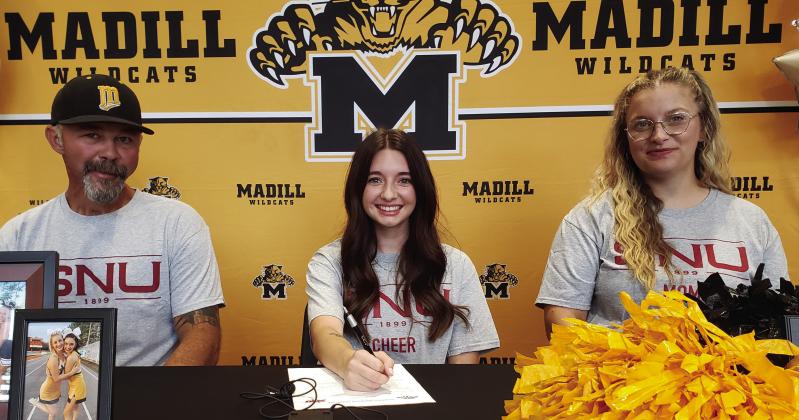 Shayla Pruitt, middle, signs to cheer for SNU. She is pictured with her parents Kenny and Maycie Pruitt. Courtesy photo