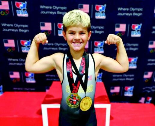 Bodie Franklin, with his two gold medals, flexes for the camera. Courtesy photos