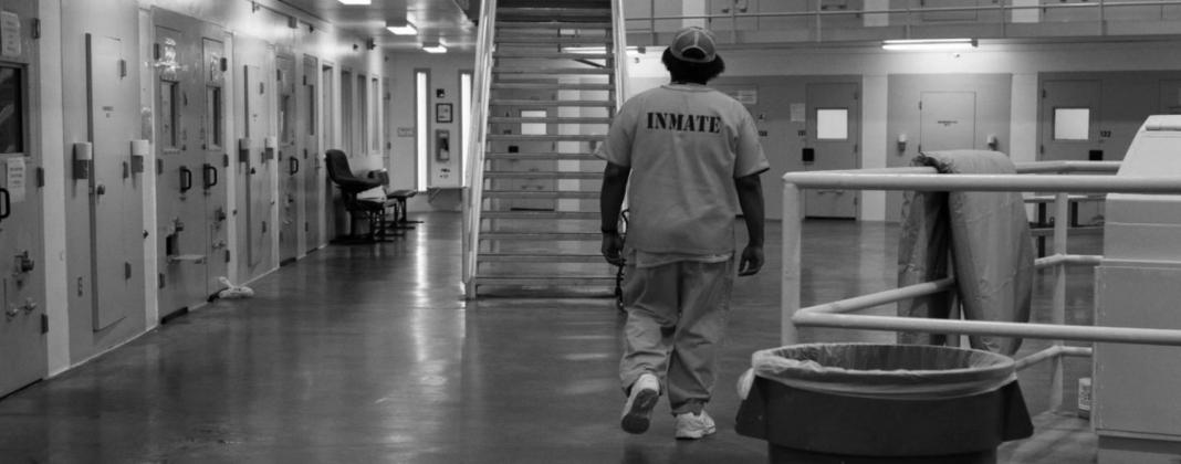 An inmate is seen walking in a common area in the mental health ward at Joseph Harp Correctional Center in Lexington. Whitney Bryen • Oklahoma Watch