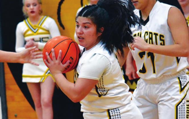 Ana Veras passes the ball to one of her teammates during the Madill v Marietta game. Unfortunately, the Lady Wildcats lost 48 to 45. Summer Bryant • The Madill Record