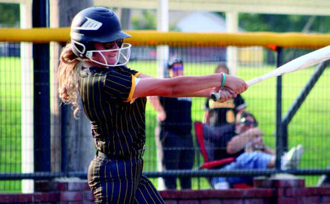 Sophomore Layne Albright swings for the fences. Summer Bryant