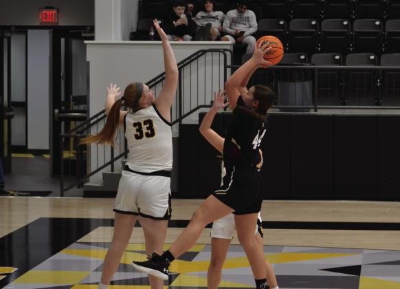 Lauren Landgraf blocks a shot by Atoka. Leslie Mowles • The Madill Record